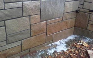 Exterior stone surface of a commercial workplace facility after mineral deposit removal